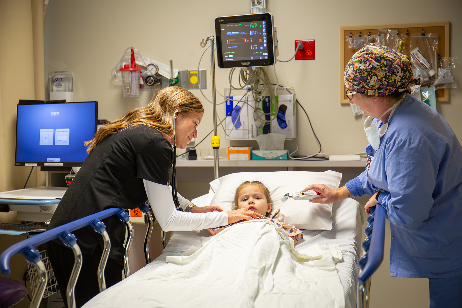 Medical staff treating child patient