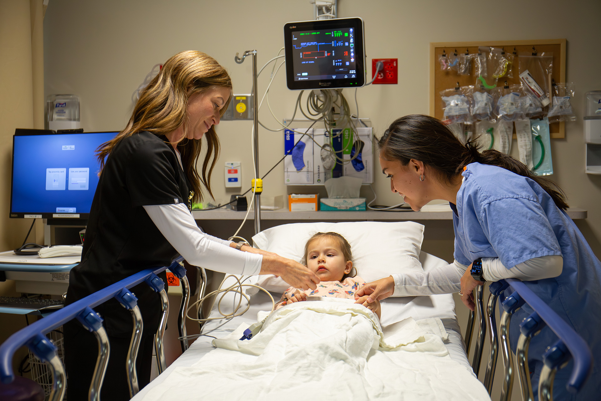 Nurses assisting child in hospital