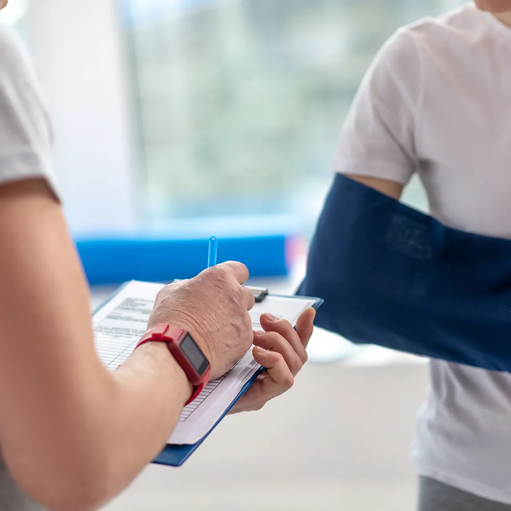 Physiotherapist specialist taking notes during a patient consultation.