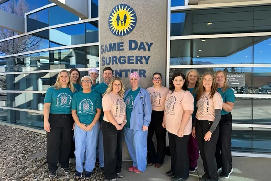 Healthcare staff standing outside Same Day Surgery Center building.